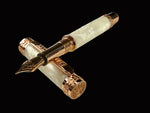 A handcrafted Edinburgh Red Gold Fountain Pen with a pearly opal body, intricate red gold hardware, and a rampant lion design on the cap and body.