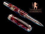 A Red Gold Rollerball Pen. The Body is hand crafted with a blend of burnt orange, red, and cream resins, like an Italian Sunset in Sienna.
The Custom Hardware is Intricately Engraved With A Rampant Lion, which adorns both the cap and finial. The Center Band Showcases A Series Of Understated Yet Distinguished Artist Designed “H” . The Fountain pen is sitting on an old manuscript with the body of the pen resting on the cap.
