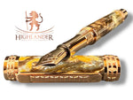 A Red Gold Fountain Pen With Red Gold JOWO #6 Nib. The Body is hand crafted with swirls of silver, Bronze, and Gold pearl resins imitating molten metals.
The Custom Hardware is Intricately Engraved With A Rampant Lion, which adorns both the cap and finial. The Center Band Showcases A Series Of Understated Yet Distinguished Artist Designed “H” . The Fountain pen is sitting on an old manuscript with the body of the pen resting on the cap.