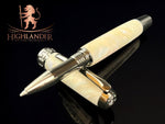 A close-up of a black titanium rollerball pen with 'Highlander' branding, featuring a marbled white and black design with a silver rampant lion emblem on the cap.