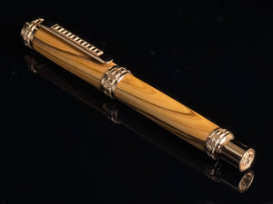 Wooden pen with silver accents on a black background