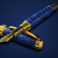 Fountain pen with blue lustrous finish and gold accents on a dark blue background
