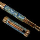 Fountain pen with marbled design and gold accents on a black background