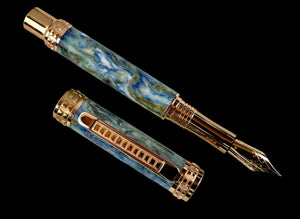 Fountain pen with marbled design and gold accents on a black background